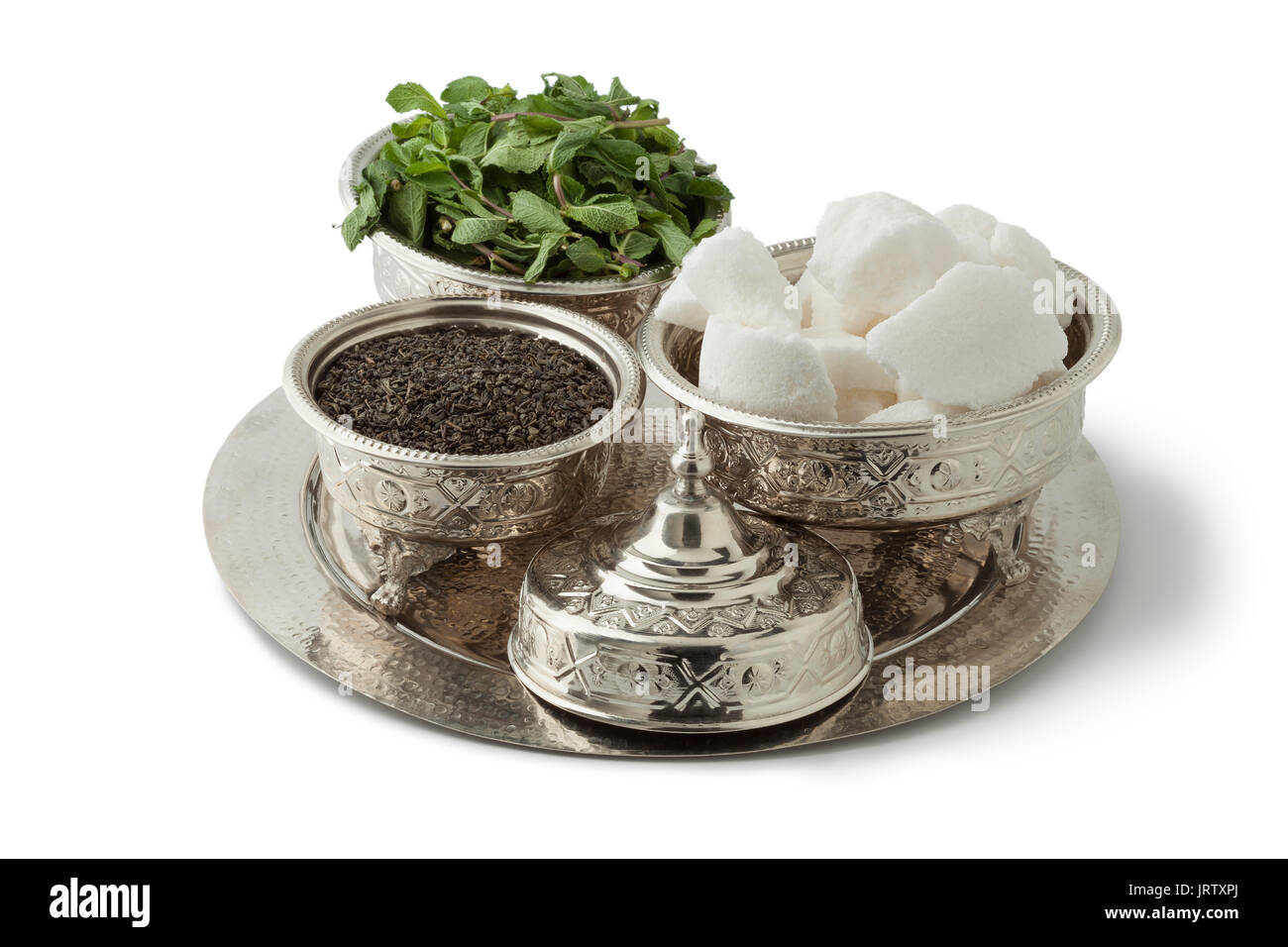 Traditional festive Moroccan silver tea set with tea, mint and sugar on white background Stock Photo