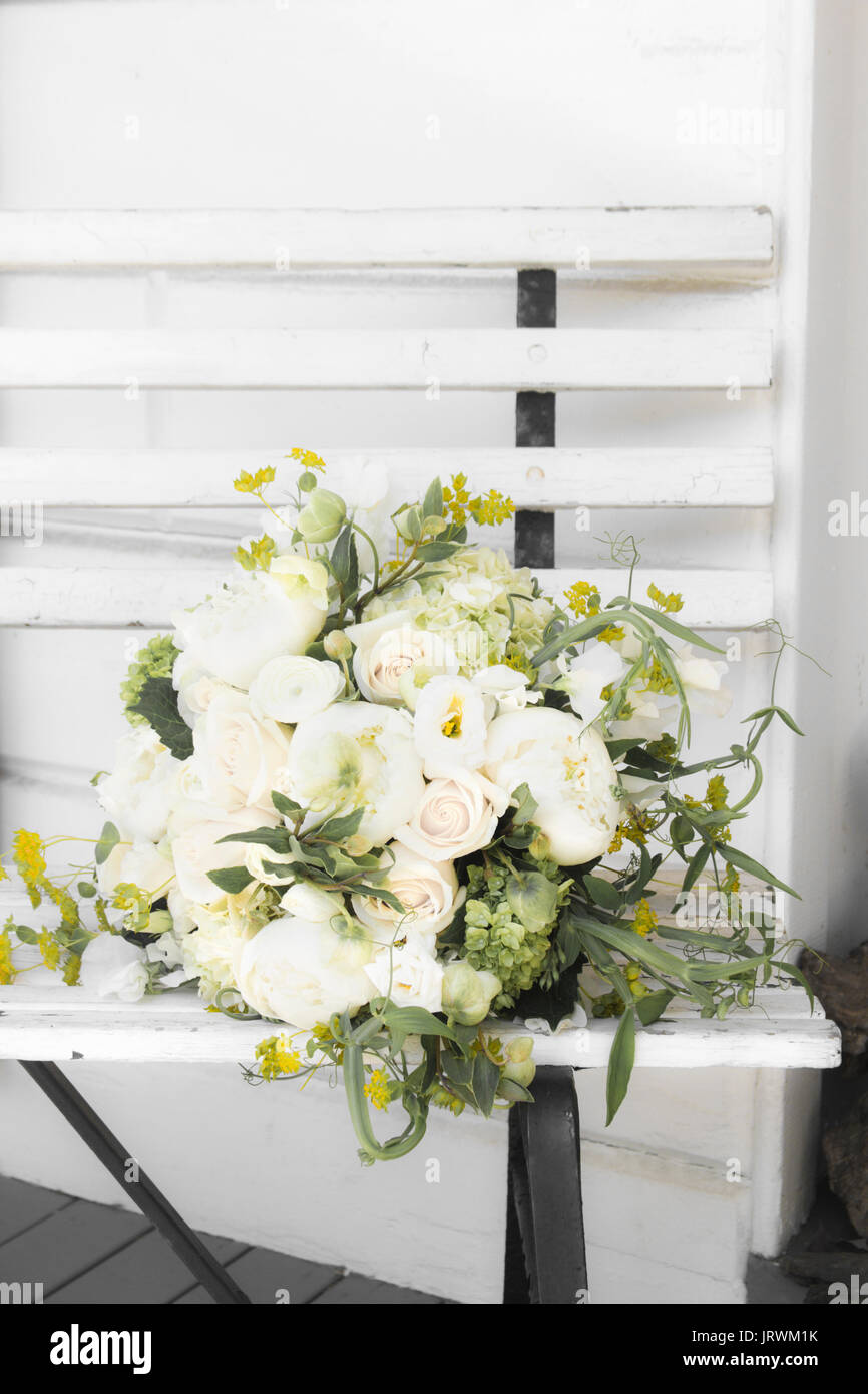 White and green flower bouquet lying on an old white wood bench Stock Photo