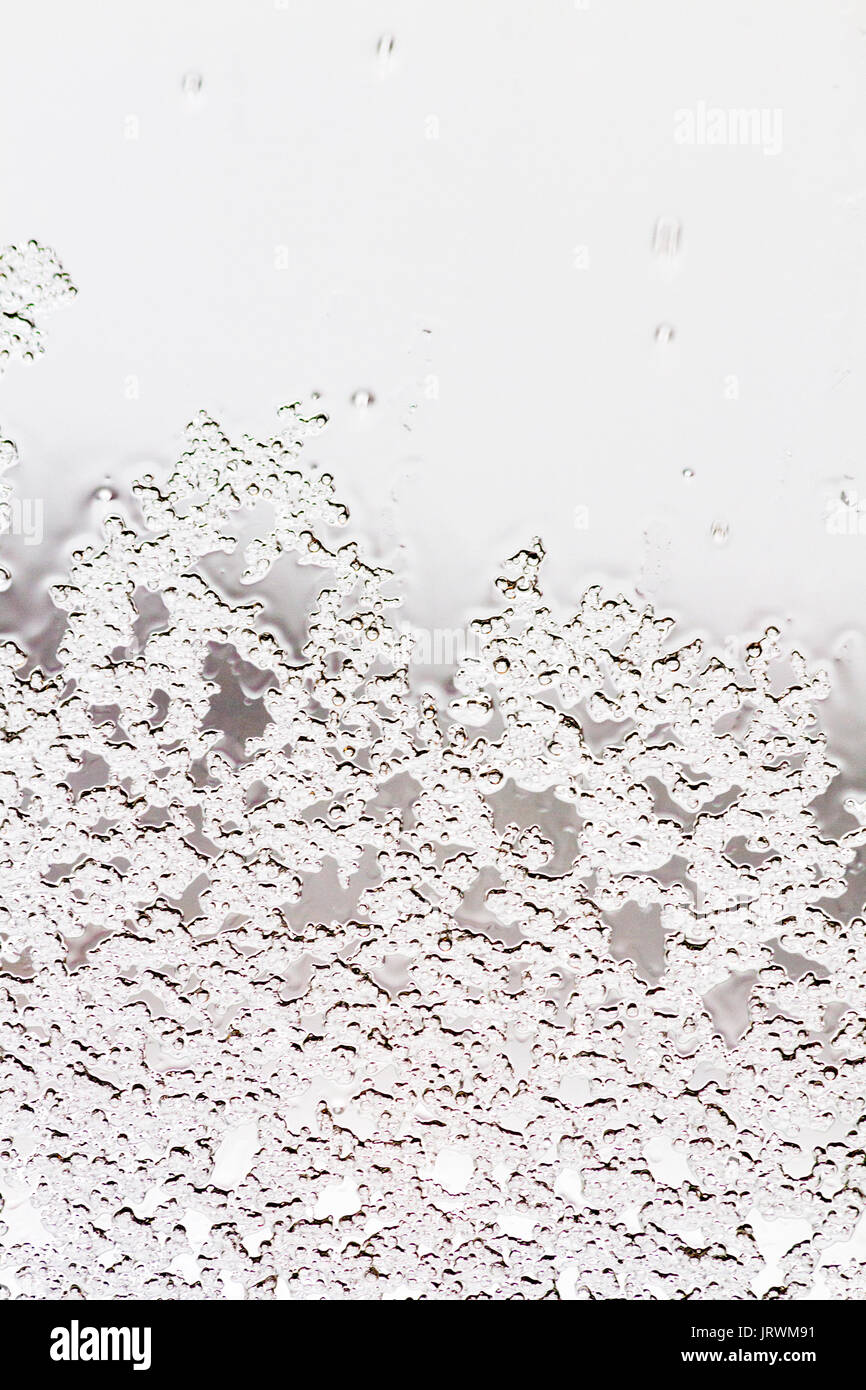 Ice crystals on a window creating an abstract pattern Stock Photo