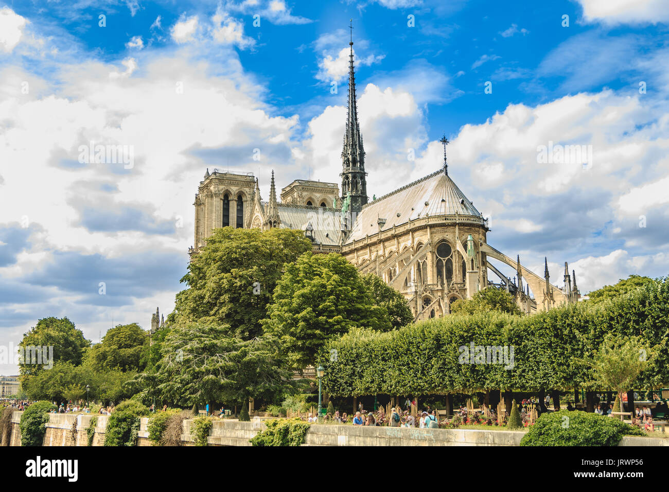 Paris, FRANCE - july 11, 2017: Wide shot of Notre-Dame cathedral in Paris, France with its gardens and tourists visiting the French capital Stock Photo