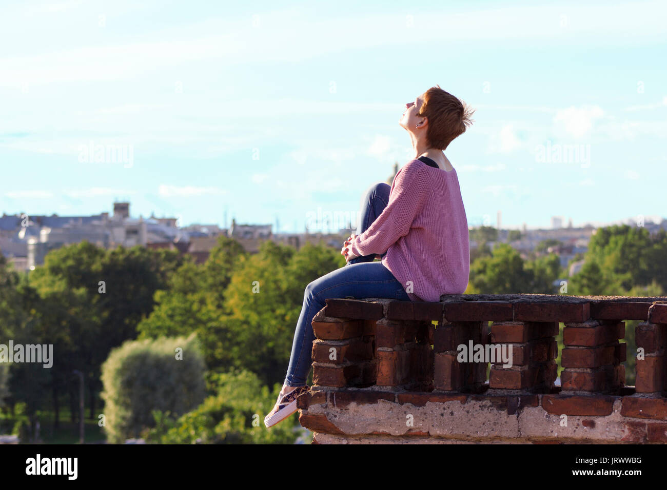 Brave girl walking on the roof of SaintPetersburg Stock Photo