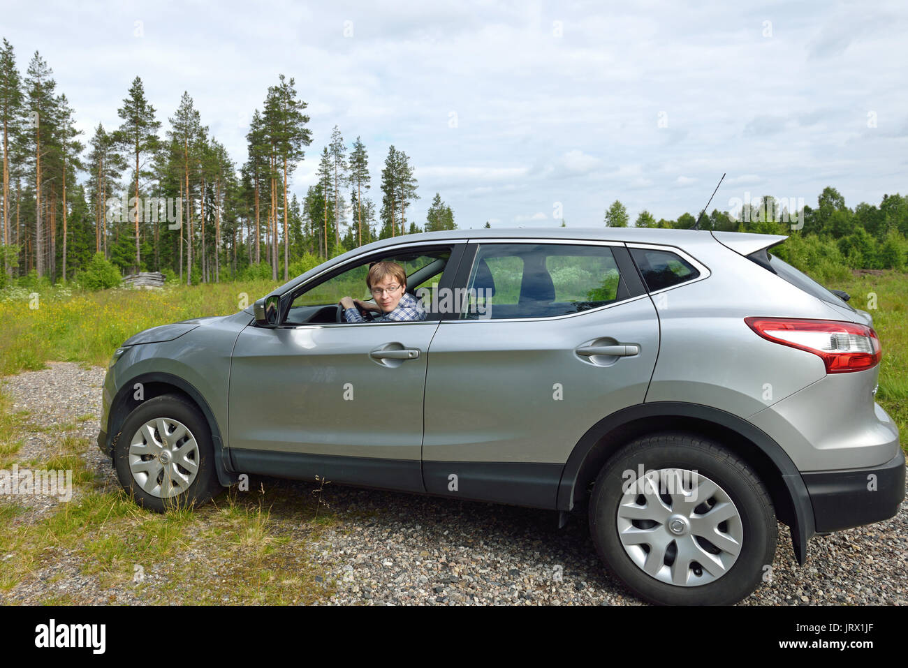 Young man driving car lapland hi-res stock photography and images - Alamy