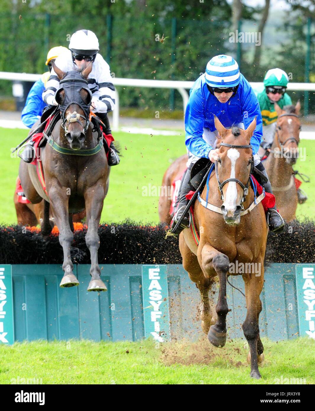Ben Button and Ruby Walsh go on to win the Kenny Galway Handicap Hurdle during Mad Hatters Day of the Galway Summer Festival at Galway Racecourse. Stock Photo