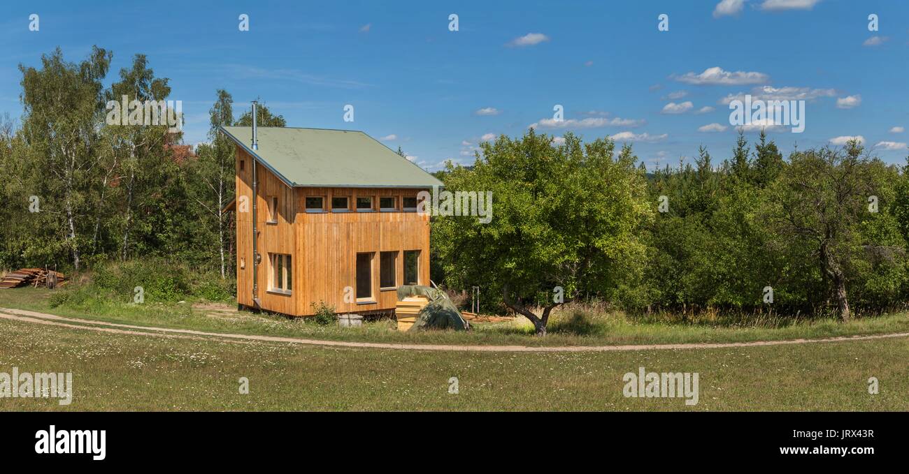 Eco-friendly, wood-house at the woods. Energy saving. Living in nature. Wooden building Stock Photo