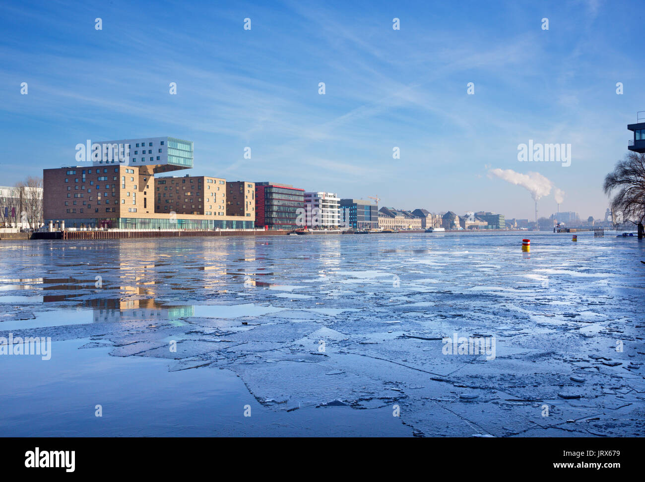 Berlin - The floting ice of ice on the Spree river and the modern buildings on the riverside. Stock Photo