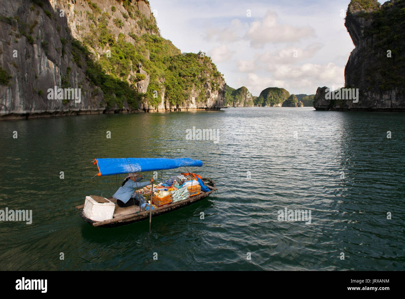 Boat woman vendor in Halong Bay, Vietnam.  Drink snack hat vendor rowing boat Halong Bay Vietnam. Stock Photo