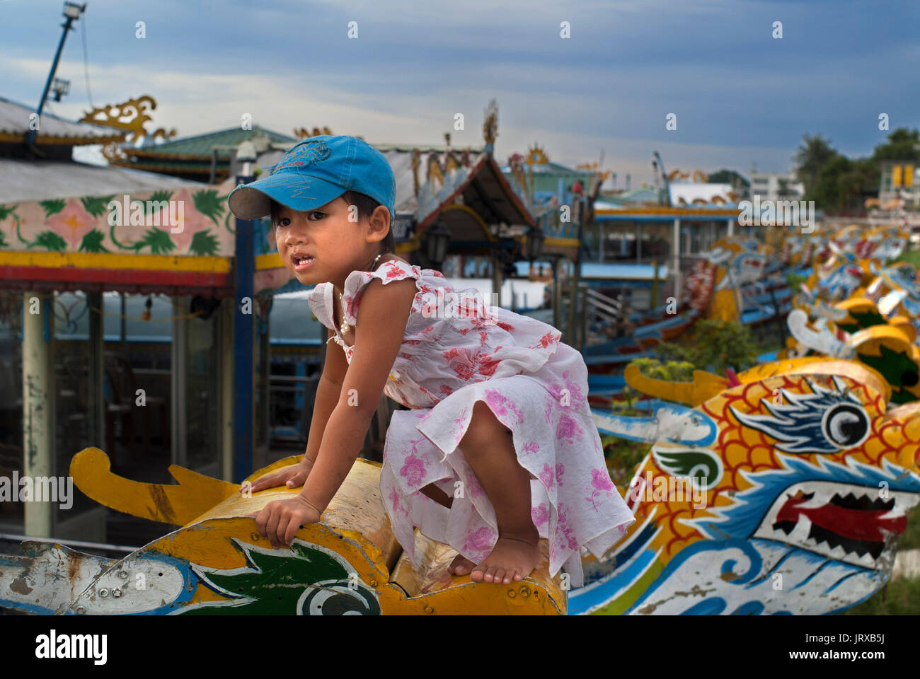 Nice girl up the Dragon boat cuise on the river Huong (Perfume River). Vietnam. Dragon head and excursion boat, Song Huong or Huong Giang or Perfume R Stock Photo