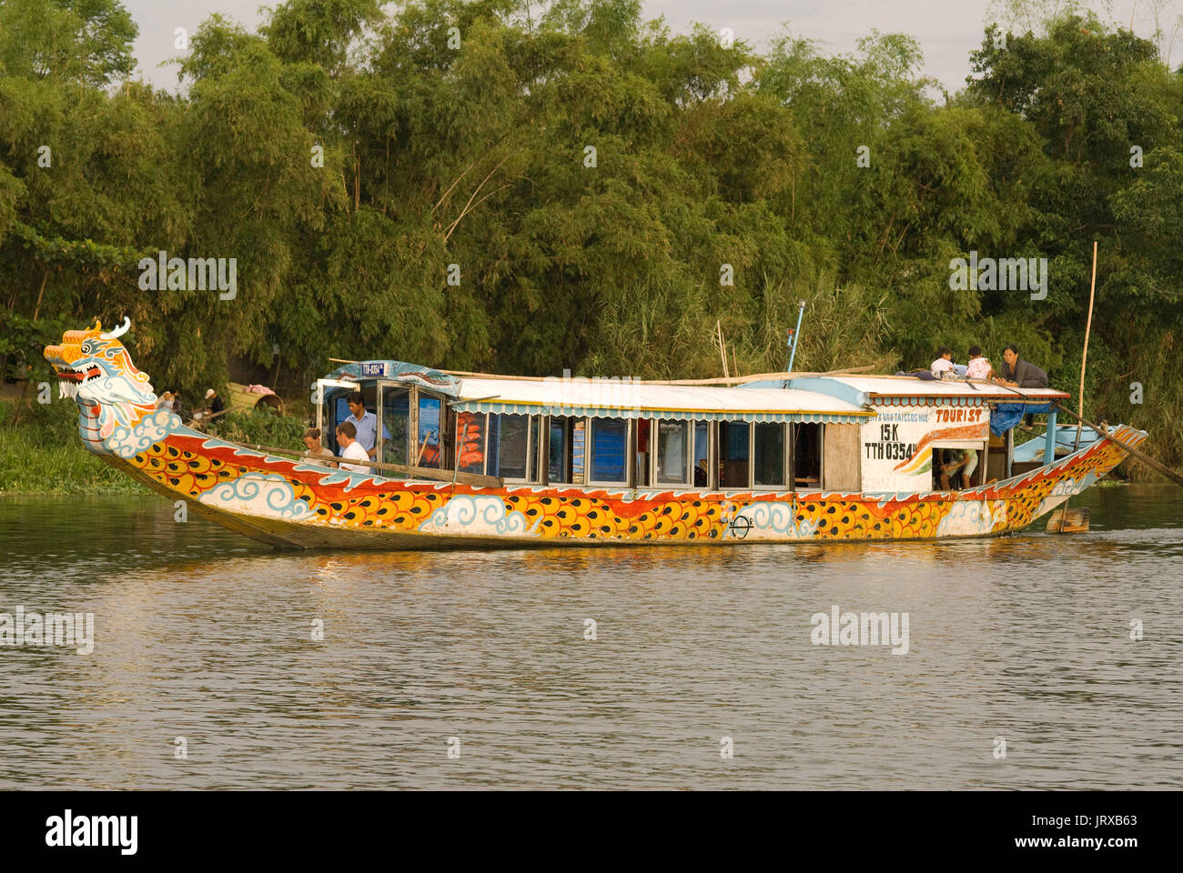 Dragon boat cuise on the river Huong (Perfume River). Vietnam. Dragon head and excursion boat, Song Huong or Huong Giang or Perfume River, near Hue, N Stock Photo