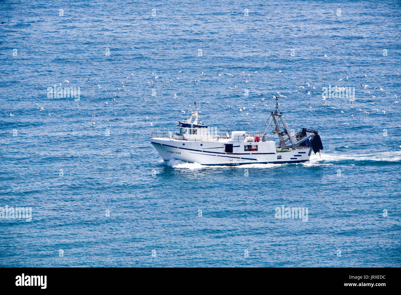 Fishing boat entering the port of Estepona, Andalusia, Spain Stock Photo