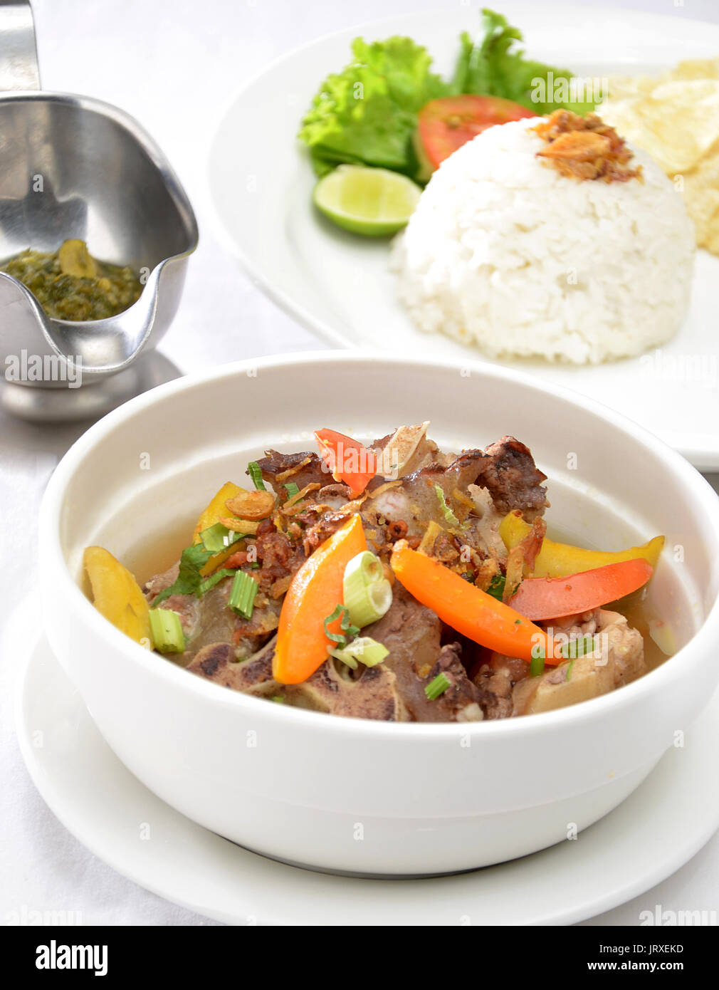 Indonesia Oxtail soup serve with rice and sambal cabe hijau, green chili paste Stock Photo