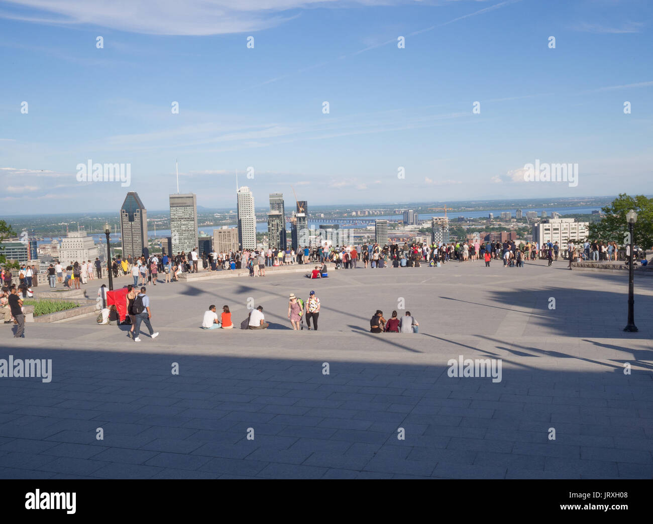 Tourists enjoying the view of downtown Montreal, Quebec City, Canada skyline from an overlook during daytime in summer Stock Photo