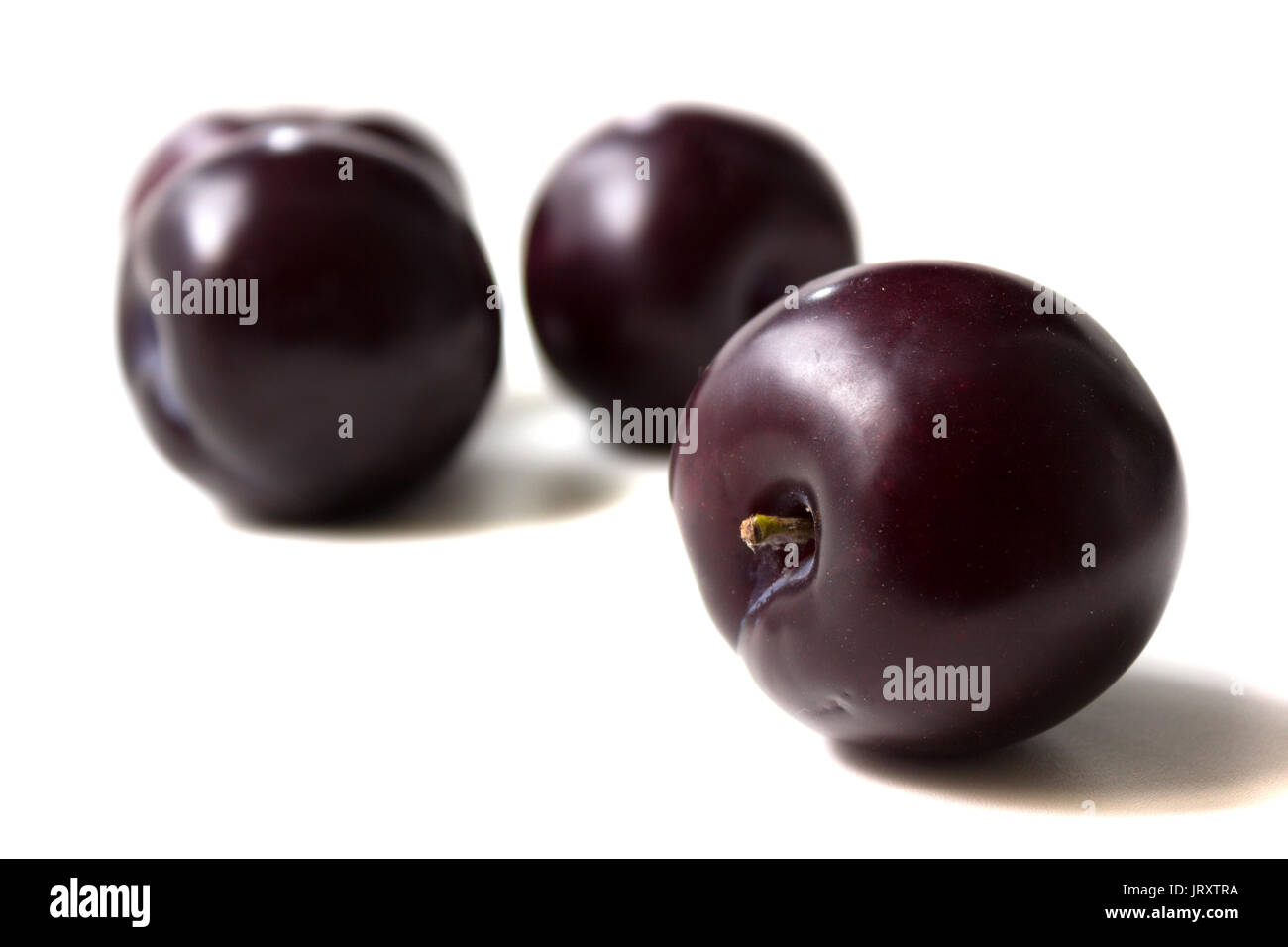 Ripe and delicious fruit of plum on white back Stock Photo
