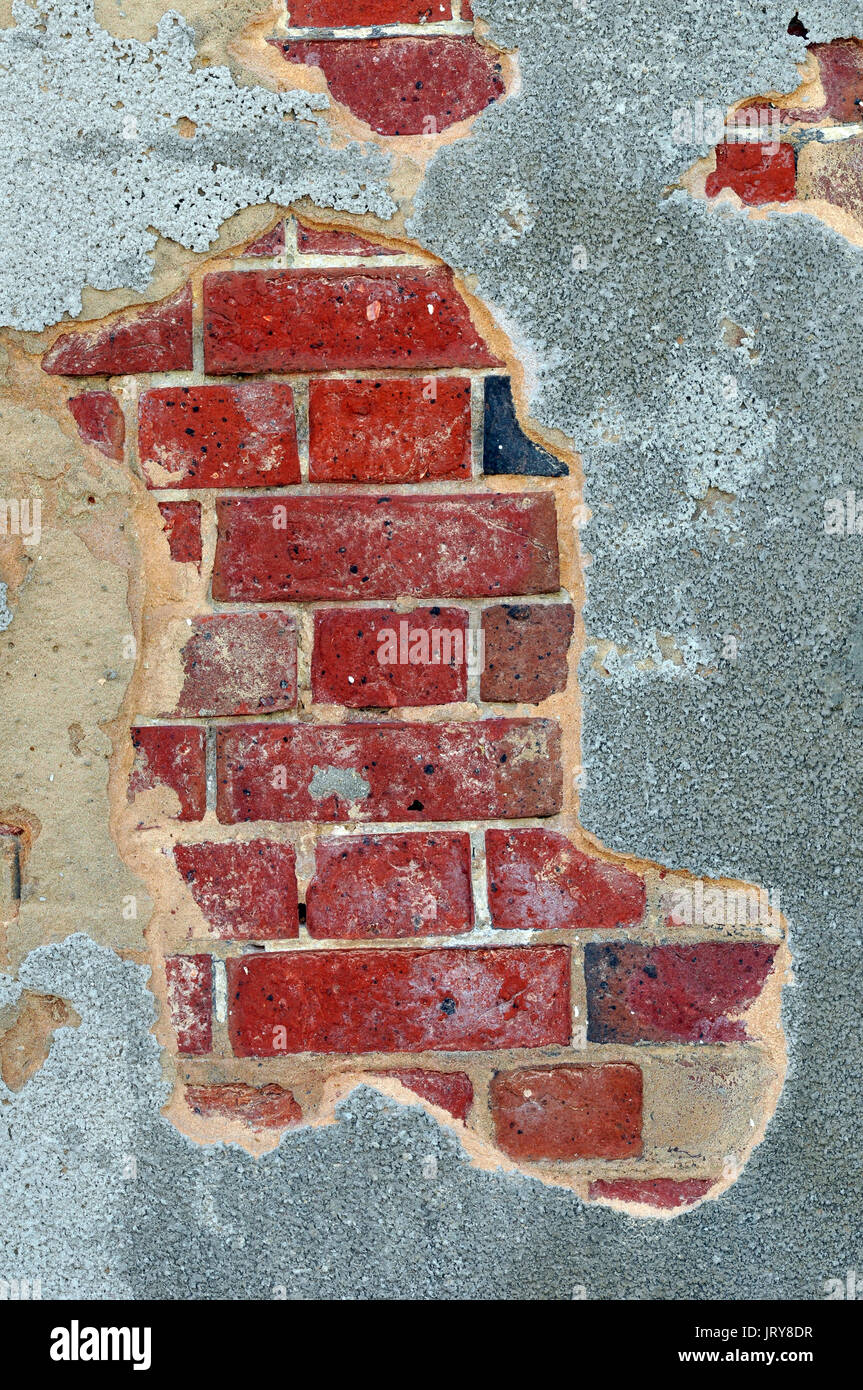 Mortar or render falling off of a wall crumbling away in a state of