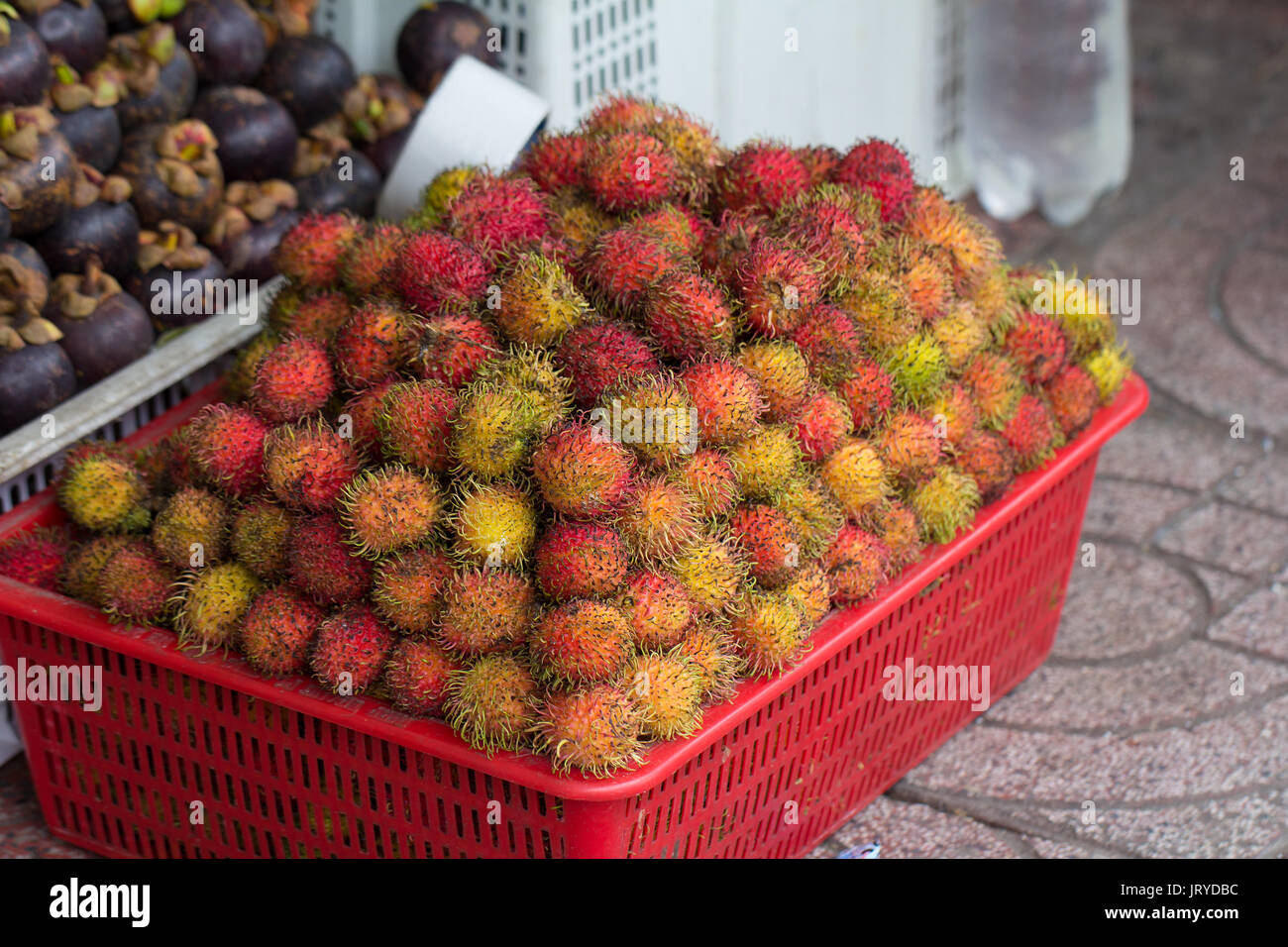 rambutan fruit in box for sale on market Stock Photo
