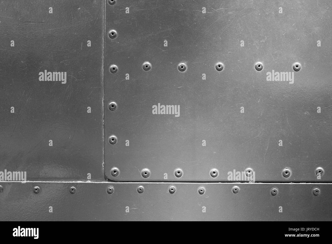 Metal plate with rivets background Stock Photo