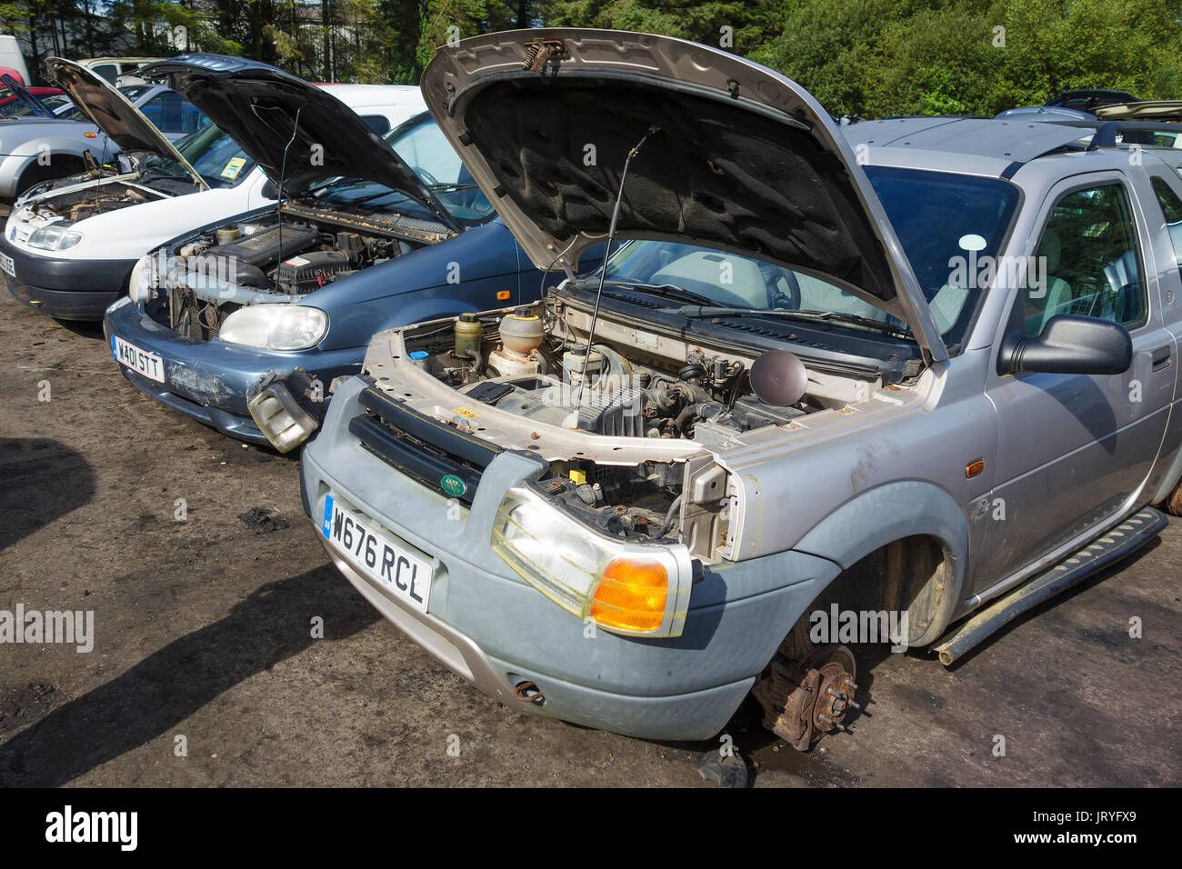old cars being used for spare parts in a scrapyard Stock Photo