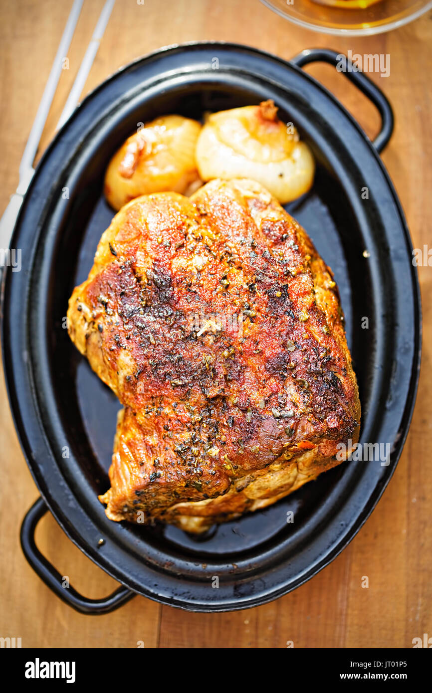 Roasted pork shoulder with onions in gravy Stock Photo Alamy