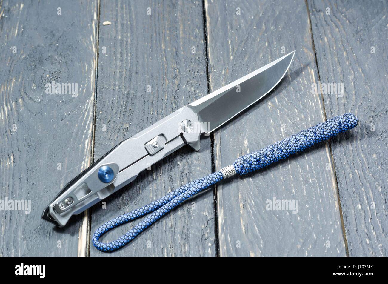 Knife with a metal handle and a blue lanyard. Back side. Metal knife