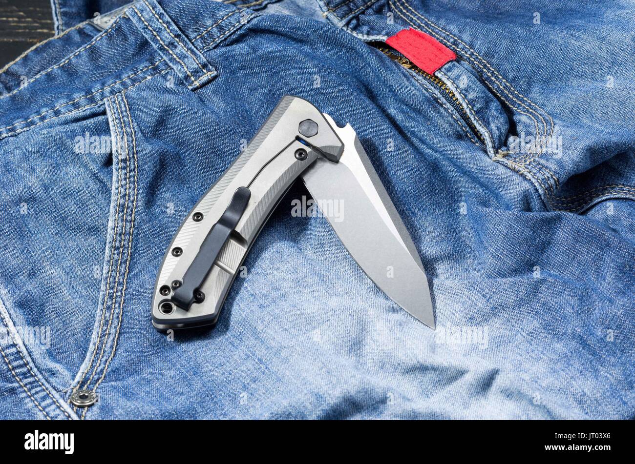 Pocket knife for everyday carrying in a curved position Stock Photo Alamy