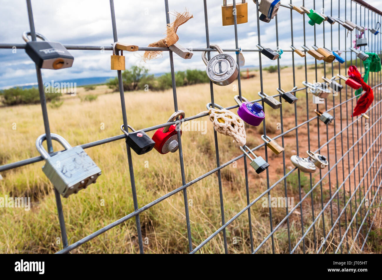 Love locks on fence behind Prada Marfa art piece outside Valentine, TX, USA Stock Photo