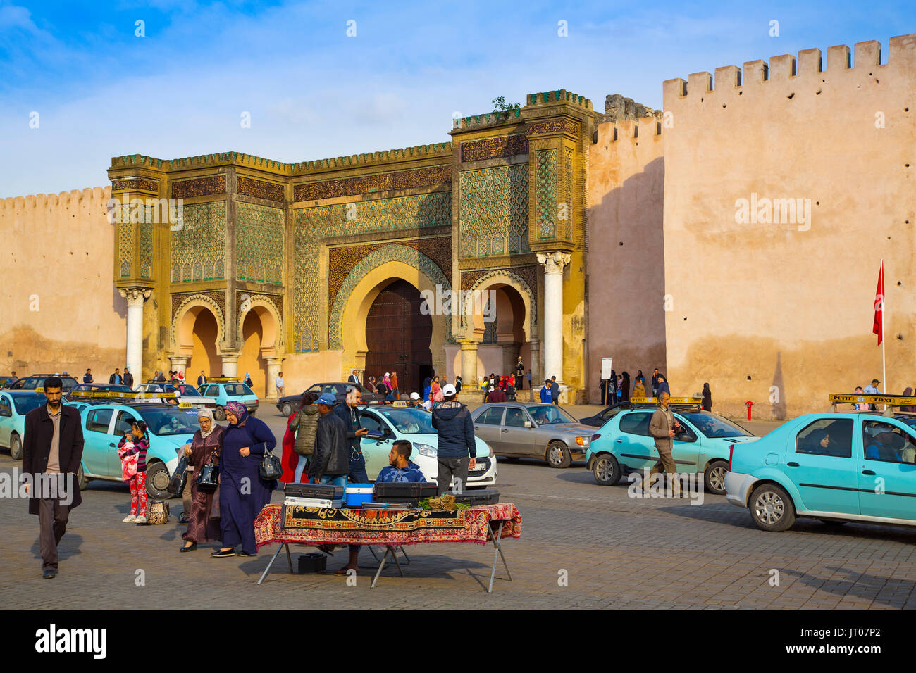 Street life scene. La Bab Mansour or Bab Masour el-Aleuj door, Lahdim Square. Old Imperial City Gate built in 1732 by Moulay Abdallah, Meknes. Morocco Stock Photo