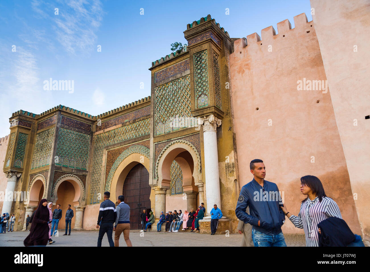 Street life scene. La Bab Mansour or Bab Masour el-Aleuj door, Lahdim Square. Old Imperial City Gate built in 1732 by Moulay Abdallah, Meknes. Morocco Stock Photo