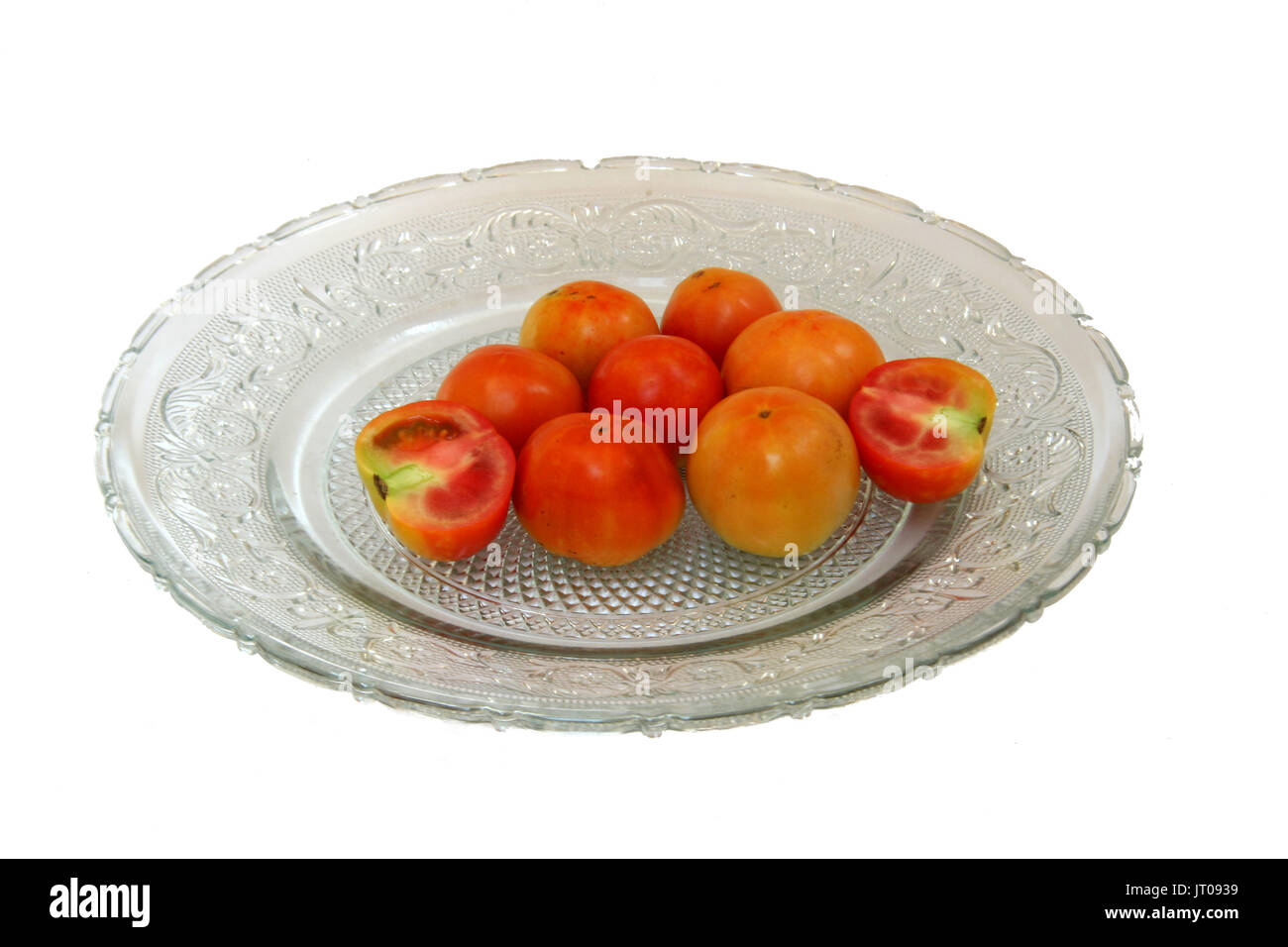 Tomatoes are red, yellow, sour, pulpy edible fruits containing vitamin C and betacarotene Stock