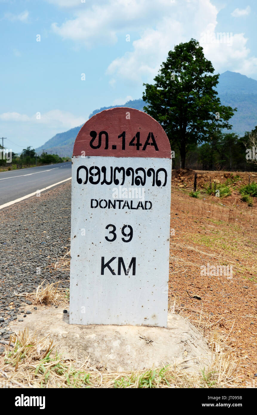 Old Milestone on the road information distance Dontalad with Pakse on May 1, 2015 in Champasak, Laos Stock Photo