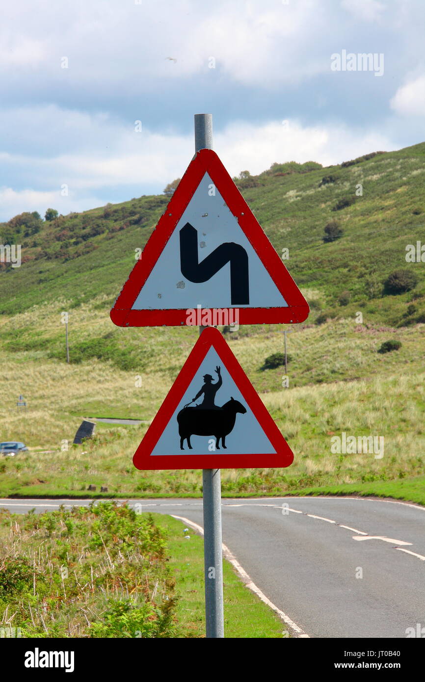 A local road sign warning motorists of Sheep on the road that has been carefully adapted by a prankster making this sign funny and memorable. Stock Photo