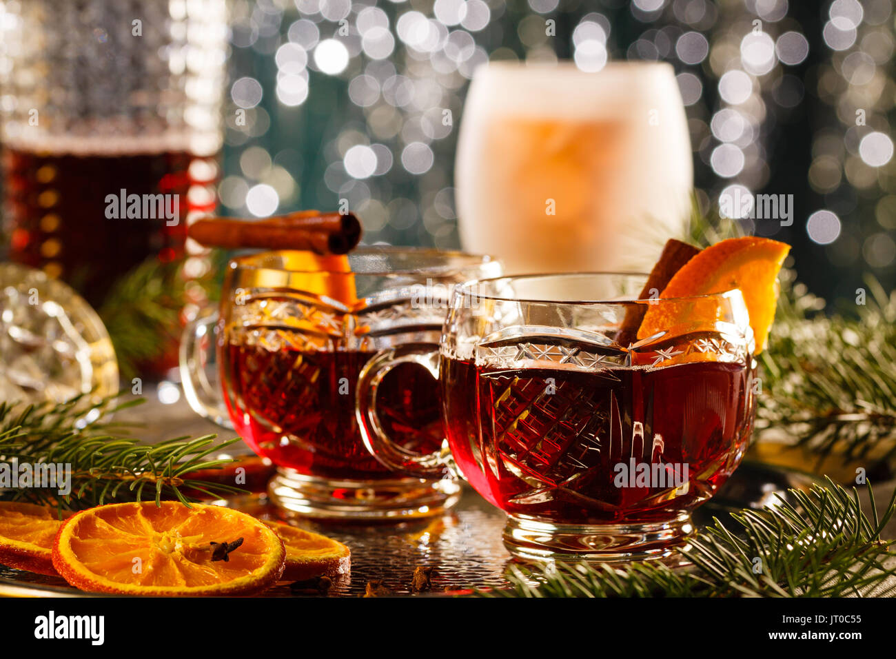 Hot mulled wine with orange slices and cinnamon sticks on Christmas time. Stock Photo