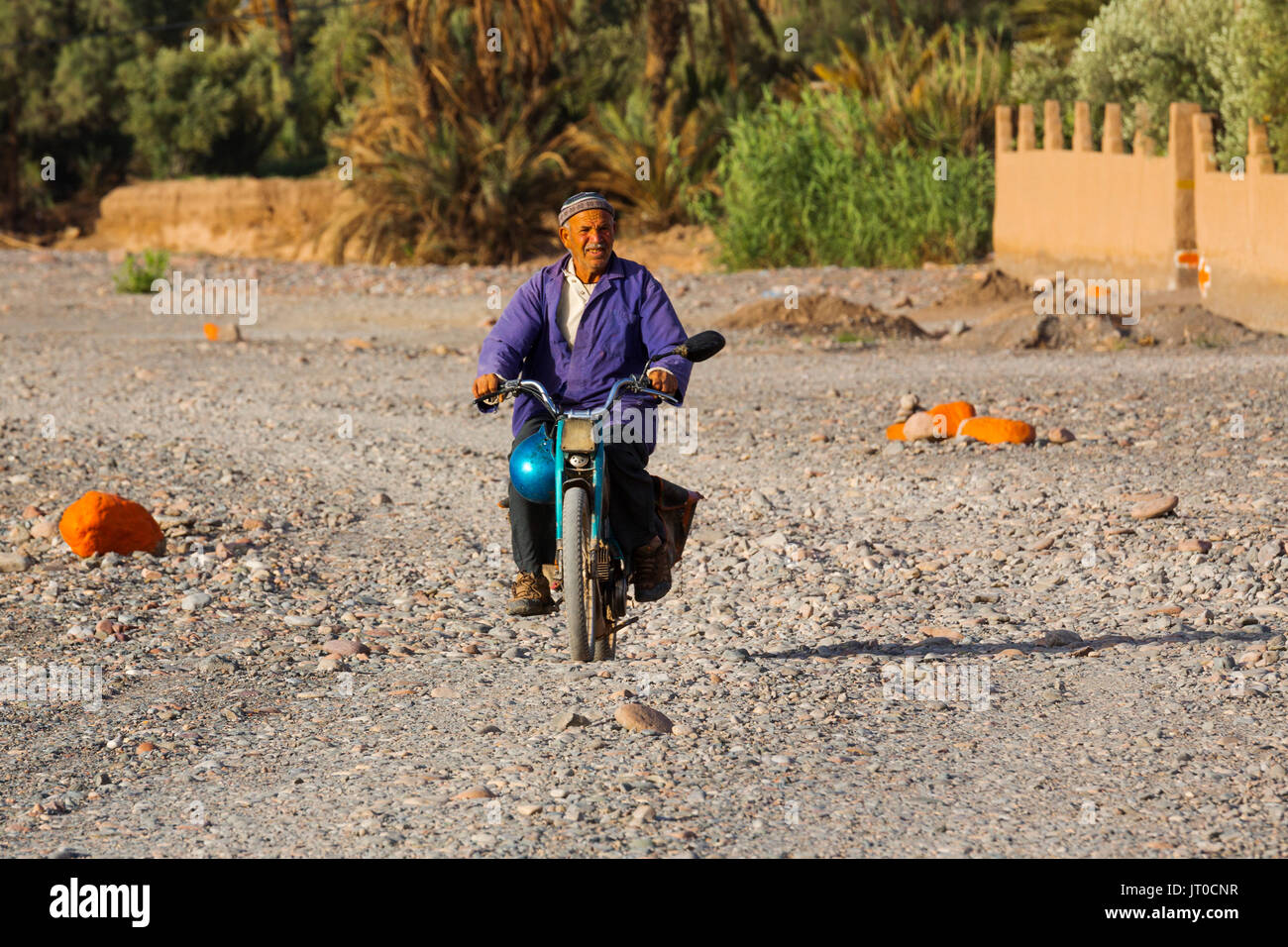 Man on a motorcycle. Hotel Kasbah Amridil, Dades Valley, Skoura. Morocco, Maghreb North Africa Stock Photo