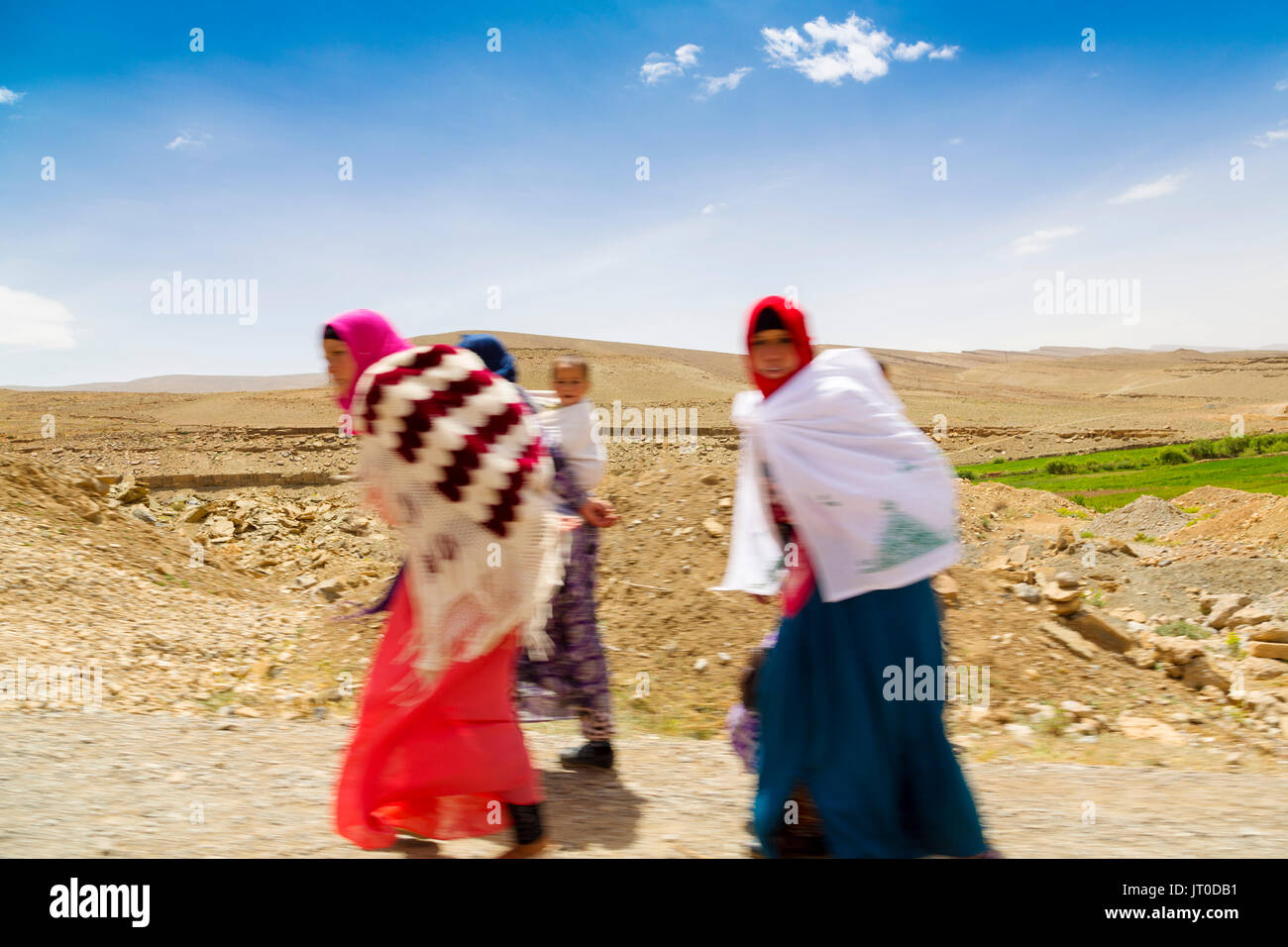 Women walking down the road. Tilmi mountain village. Dades Valley, Dades Gorges, High Atlas. Morocco, Maghreb North Africa Stock Photo