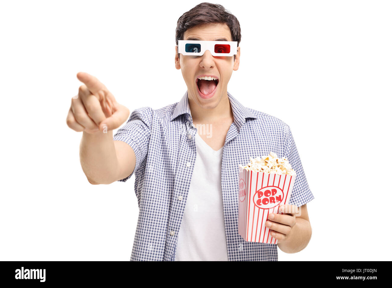 Joyful guy with a pair of 3D glasses and popcorn pointing at the camera and laughing isolated on white background Stock Photo