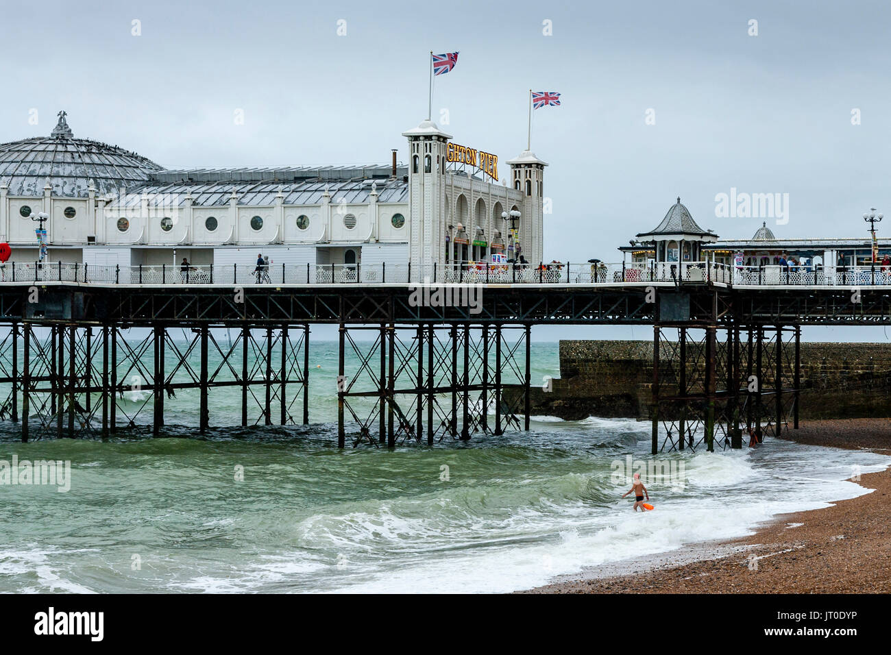 A Man Goes Swimming In the Sea Off Brighton Beach, Brighton, Sussex, UK