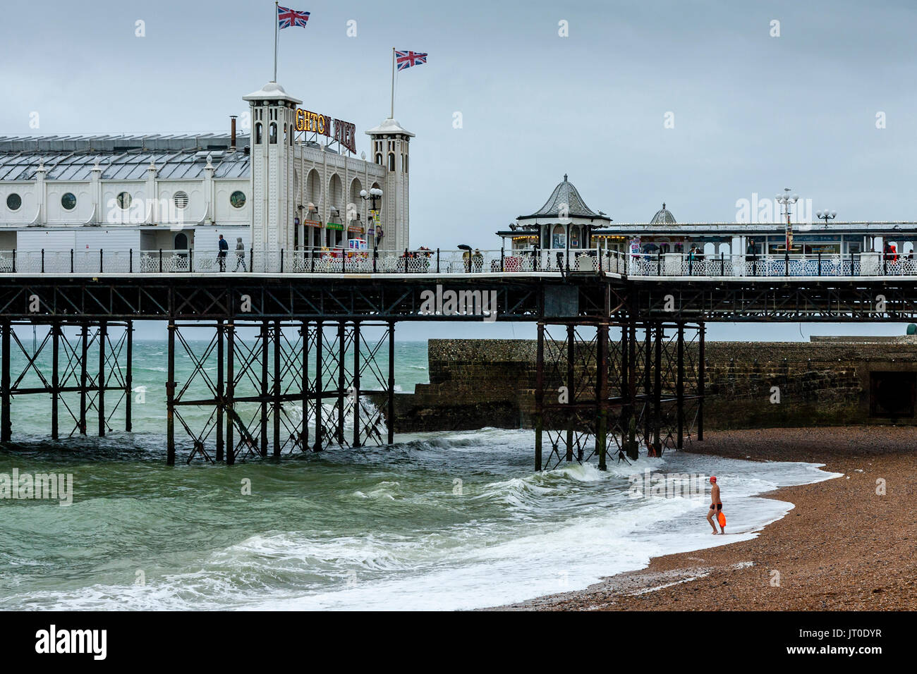 A Man Goes Swimming In the Sea Off Brighton Beach, Brighton, Sussex, UK