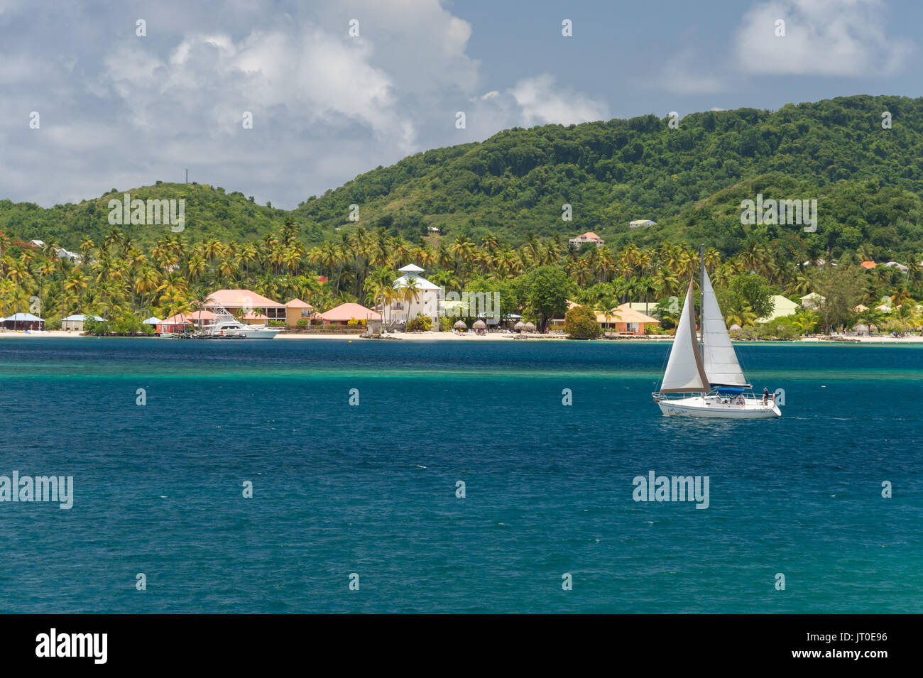 Sailboat sailing on Baie du Marin, Martinique, Caribbean, and Club Med resort in background Stock Photo
