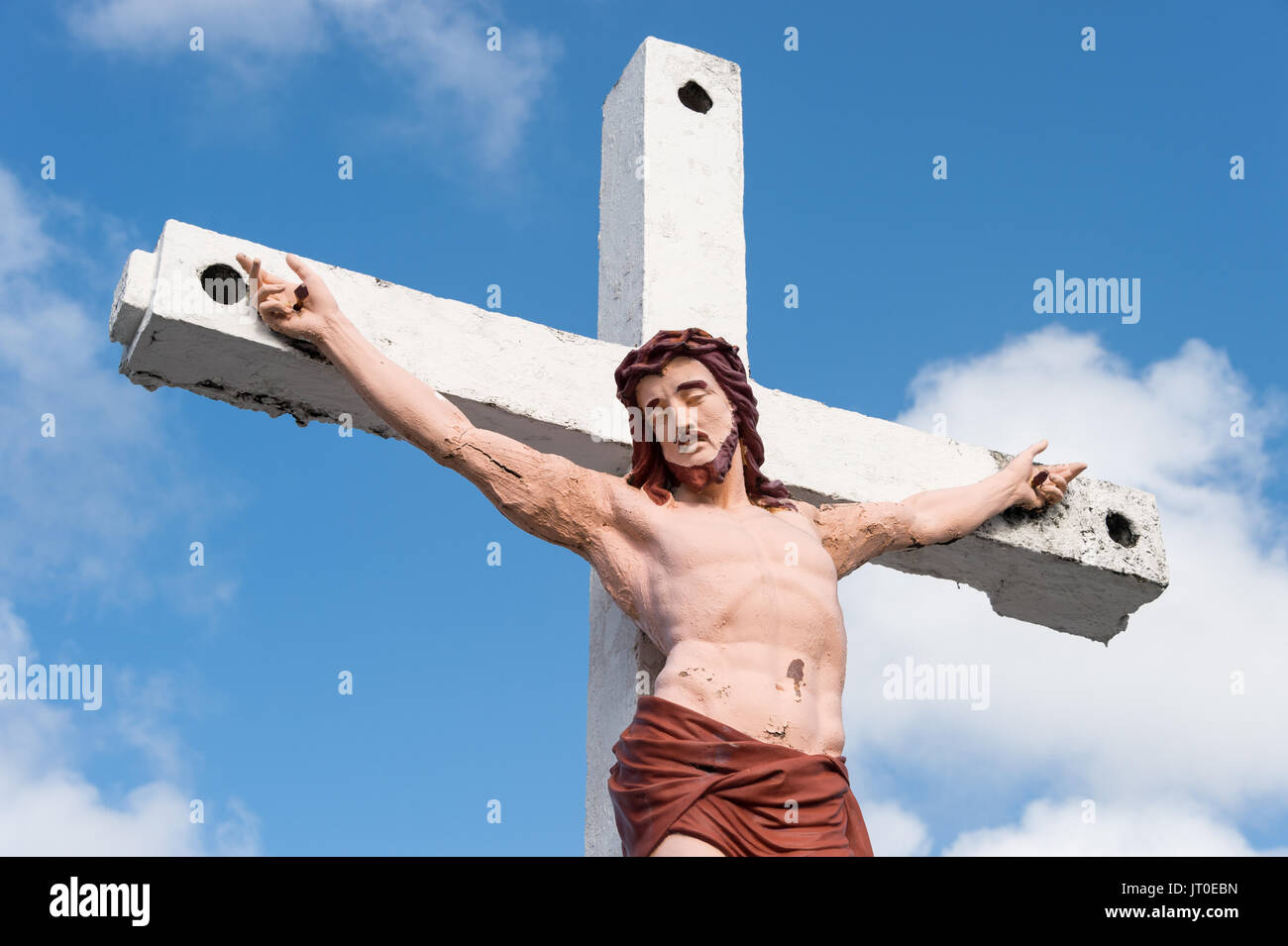 Jesus Christ on the cross over blue sky with clouds Stock Photo - Alamy