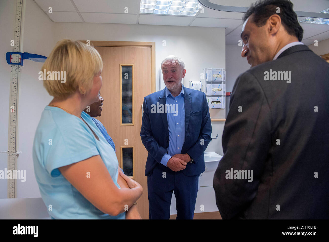 Labour leader Jeremy Corbyn speaks to Dr Onkar Sahota AM (right) and trainee phlebotomists during a visit to Somerset Family Health Practice in Southall, London. Stock Photo
