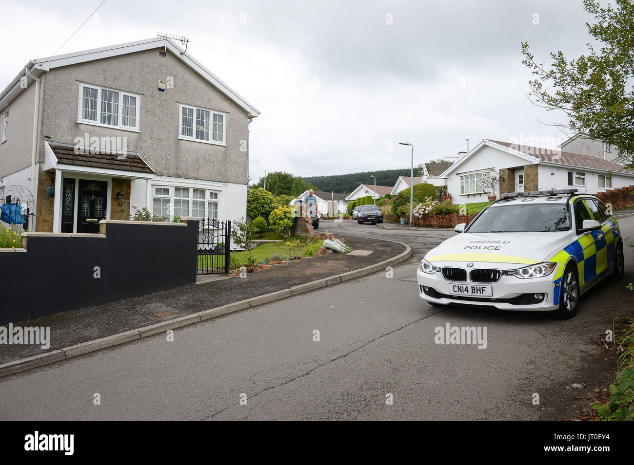 Police near the remains of a collapsed wall at a property in Heolgerrig, South Wales, where a one-year-old girl was killed after a Range Rover rolled into the wall causing it to collapse. Stock Photo