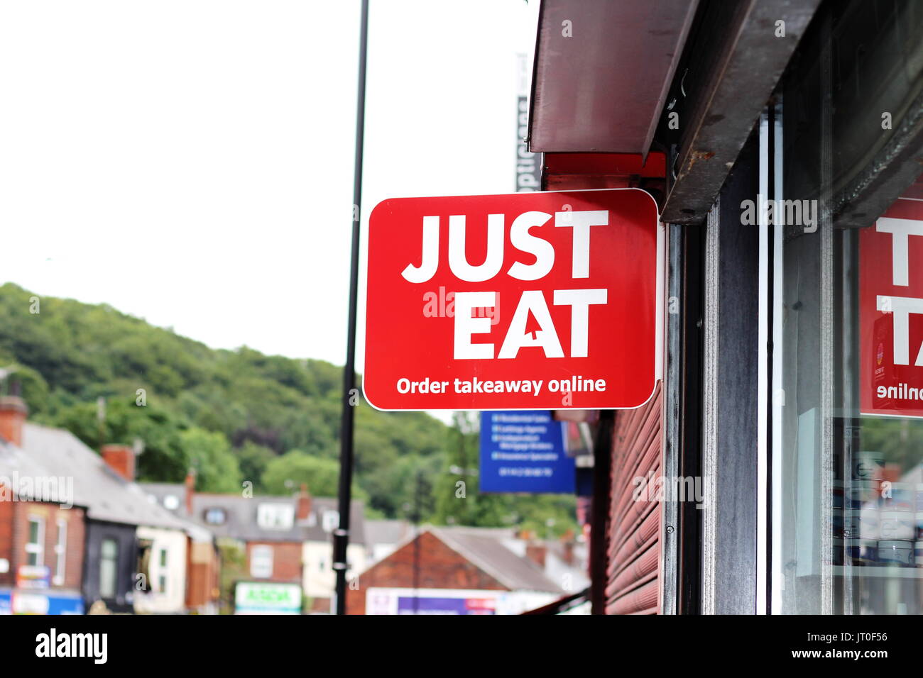 Just Eat sign outside takeaway restaurant in Woodseats, Sheffield Stock Photo