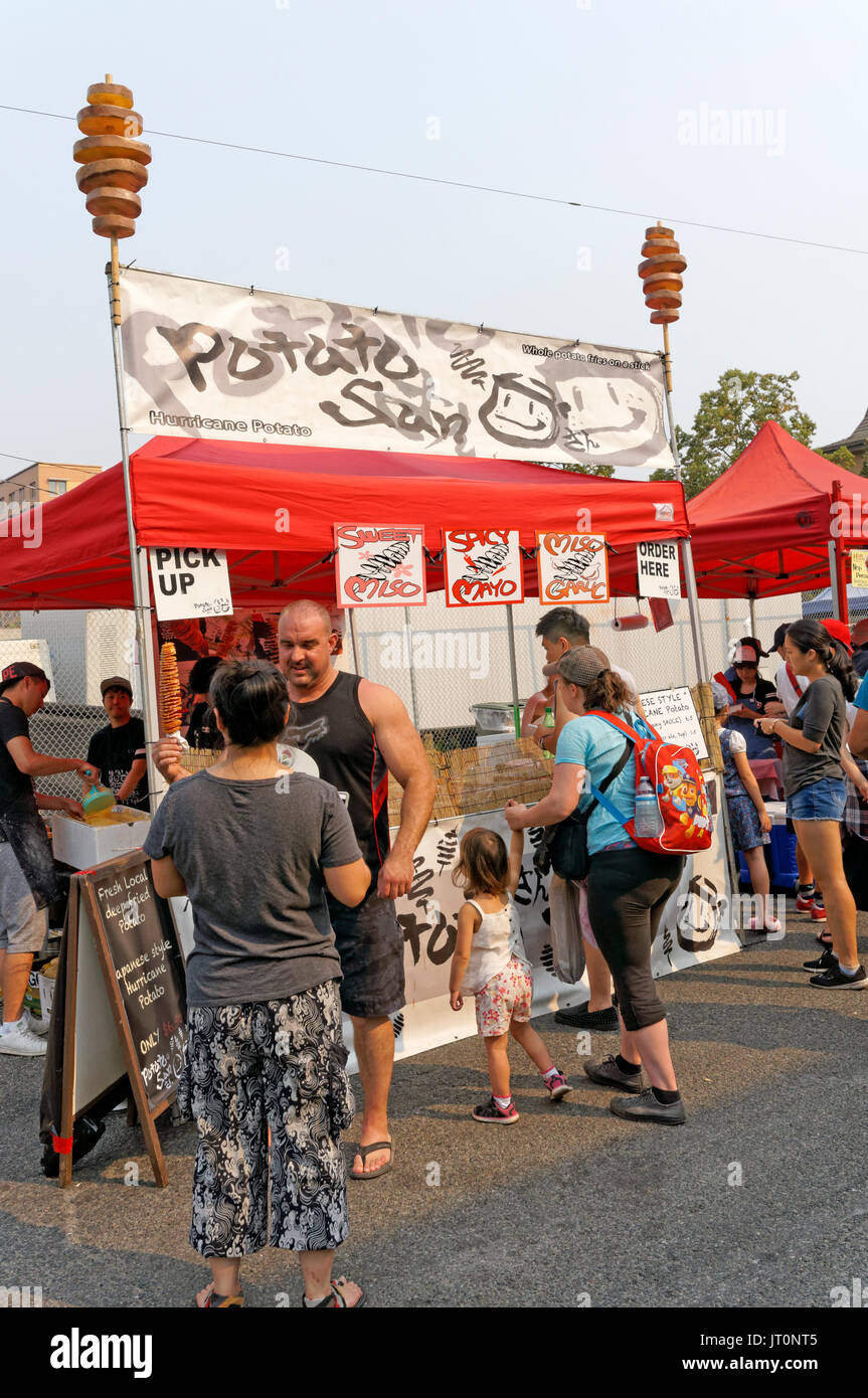 People buying Japanese style hurricane potato fast food at the annual Powell Street Festival in Japantown, Vancouver, British Columbia, Canada Stock Photo