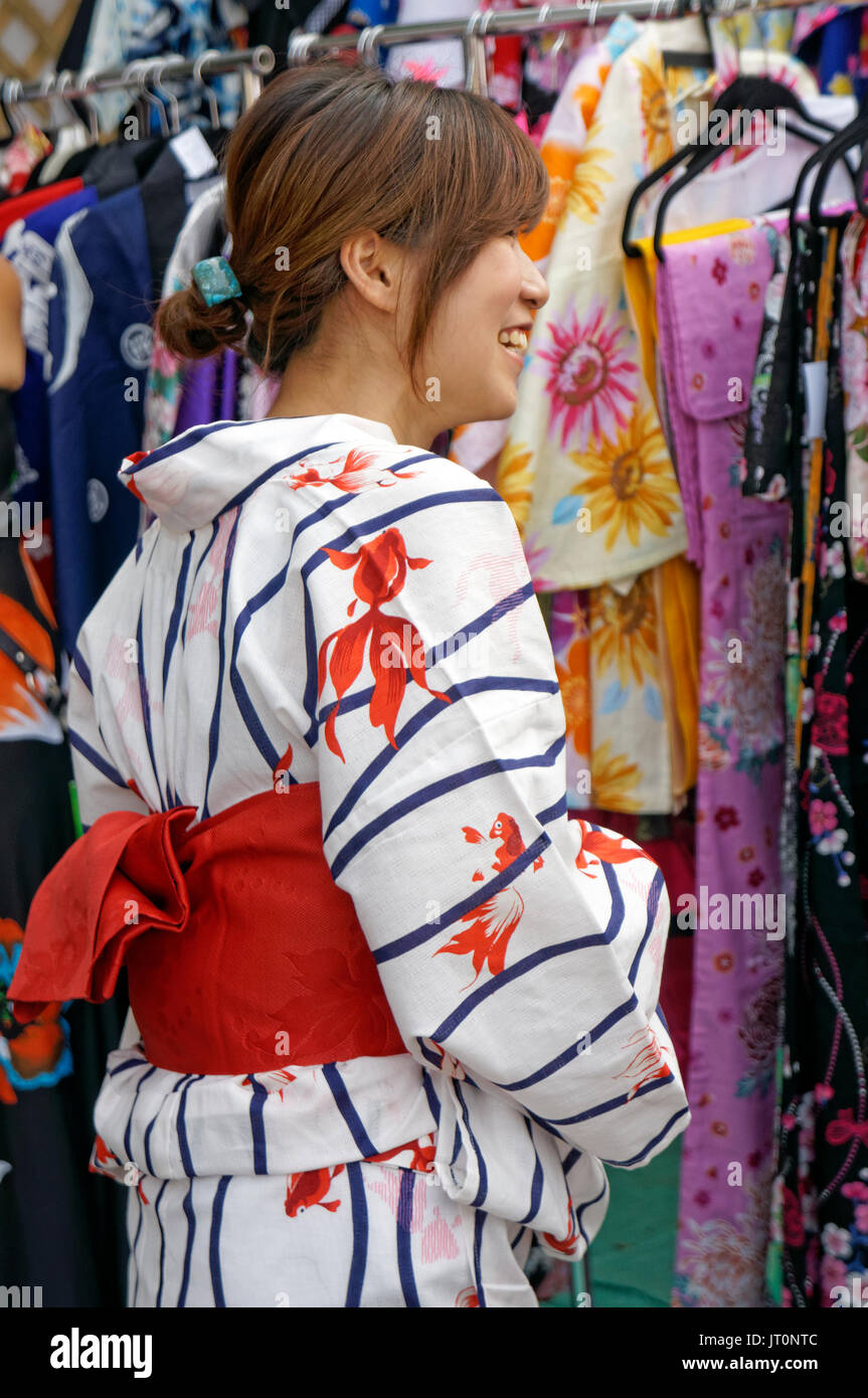 A young Japanese woman dressed in a Japanese Kimono shares a smile at the annual Powell Street Festival in Japantown, Vancouver, British Columbia, Canada Stock Photo