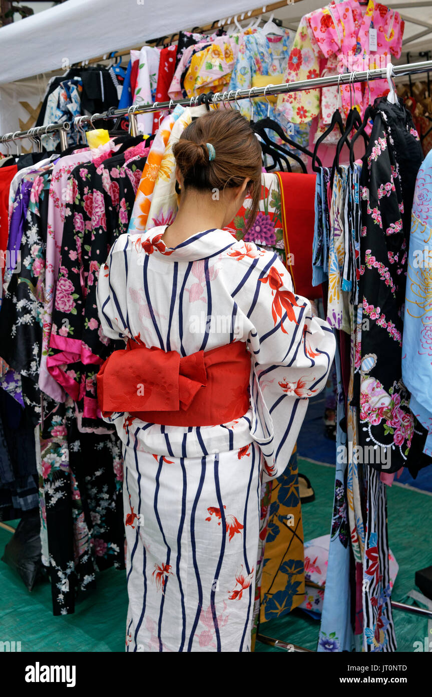 A woman in a traditional Japanese Kimono looking at clothing for sale at the annual Powell Street Festival in Japantown, Vancouver, BC, Canada Stock Photo
