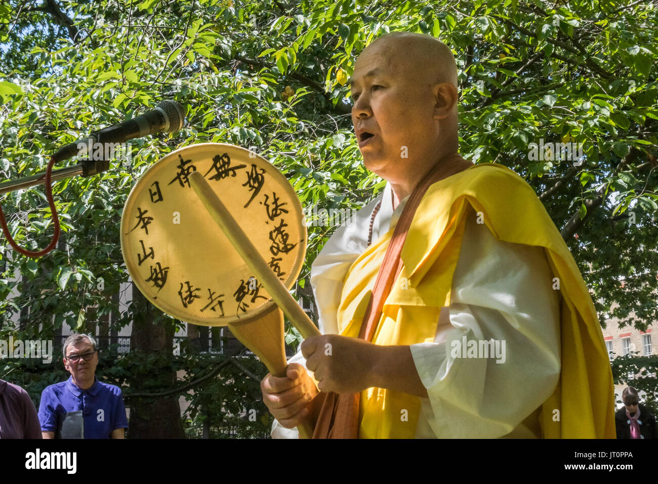 London, UK. 6th Aug, 2017. London, UK. 6th August 2017. Buddhist monk from the Battersea monastery and Peace Pagoda Reverend Gyoro Nagase recites a prayer at the London CND ceremony in memory of the victims, past and present on the 72nd anniversary of the dropping of the atomic bomb on Hiroshima and the second atomic bomb dropped on Nagasaki three days later. After a number of speeches and performances there was a minute's silence during which the Deputy Mayor of Camden and others laid flowers around the commemorative cherry tree. Peter Marshall ImagesLive (Credit Image: © Peter Marshall/Im Stock Photo