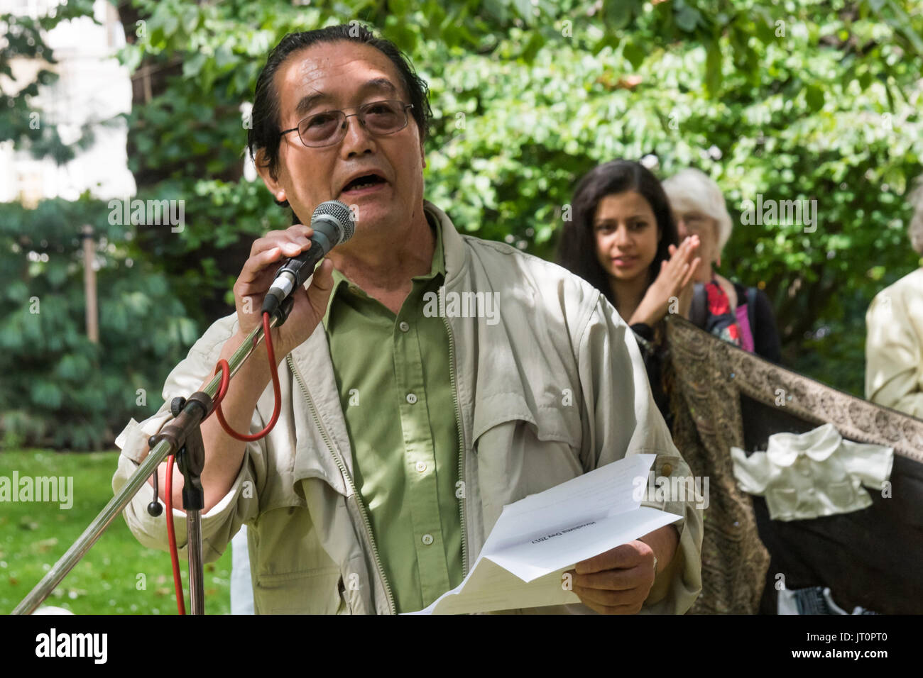 London, UK. 6th Aug, 2017. London, UK. 6th August 2017. A Japanese man speaks about the Fukushima disaster at the London CND ceremony in memory of the victims, past and present on the 72nd anniversary of the dropping of the atomic bomb on Hiroshima and the second atomic bomb dropped on Nagasaki three days later. He organises a regular Friday portest about FUkushima at the Japanese embassy and TEPCO offices. After a number of speeches and performances there was a minute's silence during which the Deputy Mayor of Camden and others laid flowers around the commemorative cherry tree. Peter Marsh Stock Photo