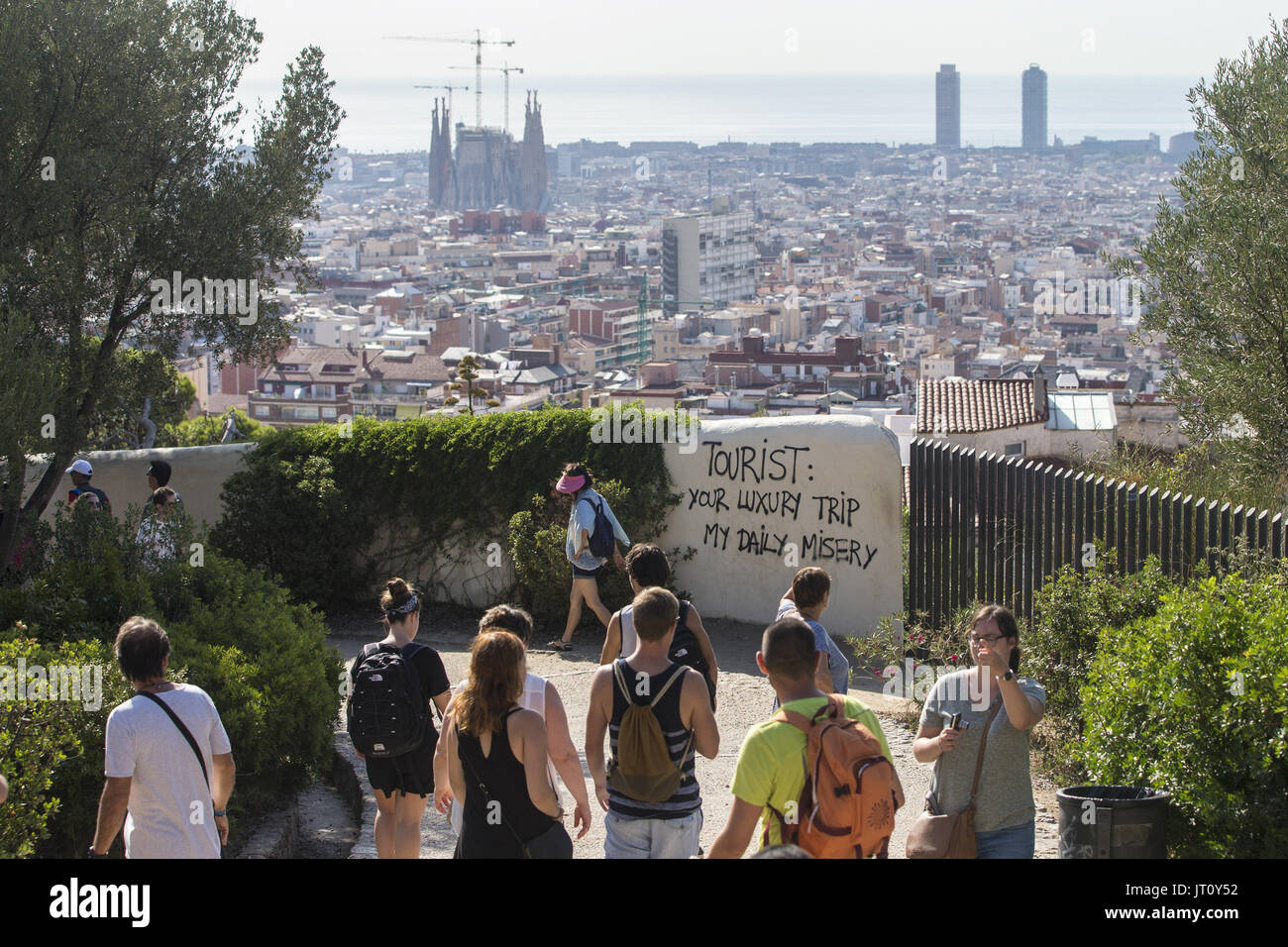 A graffiti against tourists is seen at the Guell Park in Barcelona, Spain, on 07 august 2017. The so called 'tourist phobia' is rising amongst some people in Barcelona against the massive number of tourist visiting the city. The Association of Hotels in Barcelona has demanded action against this type of vandalic acts related to the 'tourist phobia'. According to hotels, the recent 'hate' towards tourists is totally related to the flats rented illegally to tourists. EFE/Quique Garcia Stock Photo