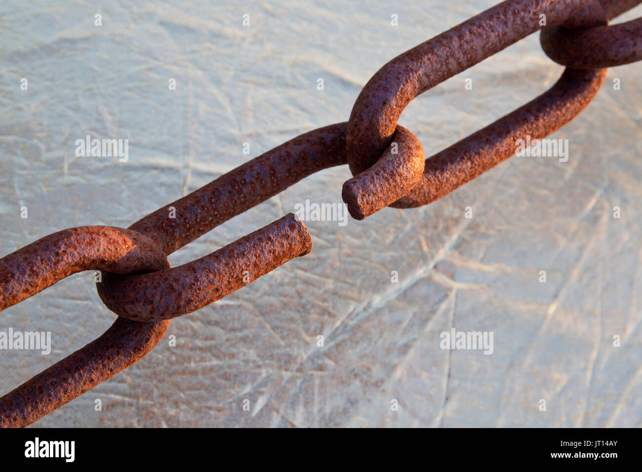Connecting rusty chain links, exposed to Coastal Climate. Stock Photo