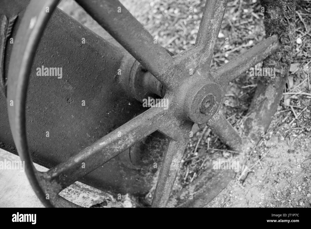 A spoked wheel from an old, antique water well pump, rusted, with a lot of patina. Stock Photo