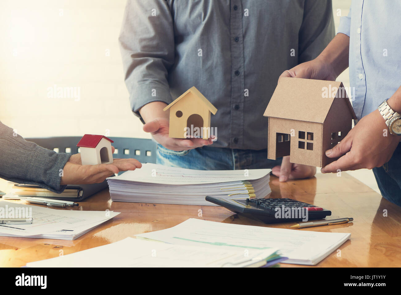 Engineer and Architect concept, Engineer Architects office team working and discussing house plan with blueprints and house model, Vintage Effect Stock Photo
