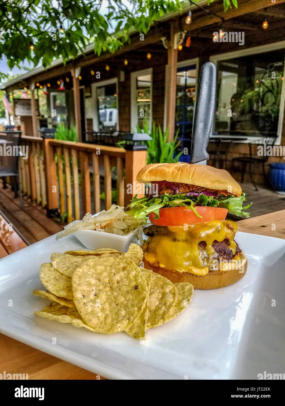 Pork belly burger served at Sweet Basil Cafe in Cannon Beach, Oregon, USA. Burger with a slab of pork belly, cheese and the rest. Stock Photo